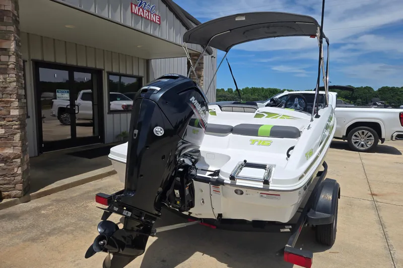 Slide: The Image of 2022 Tahoe T16 boat with Mercury outboard motor at dealership, parked on trailer. - 5