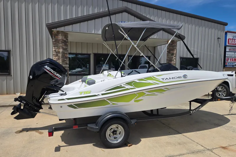 Slide: The Image of 2022 Tahoe T16 boat with Mercury engine, parked outside a building. - 6