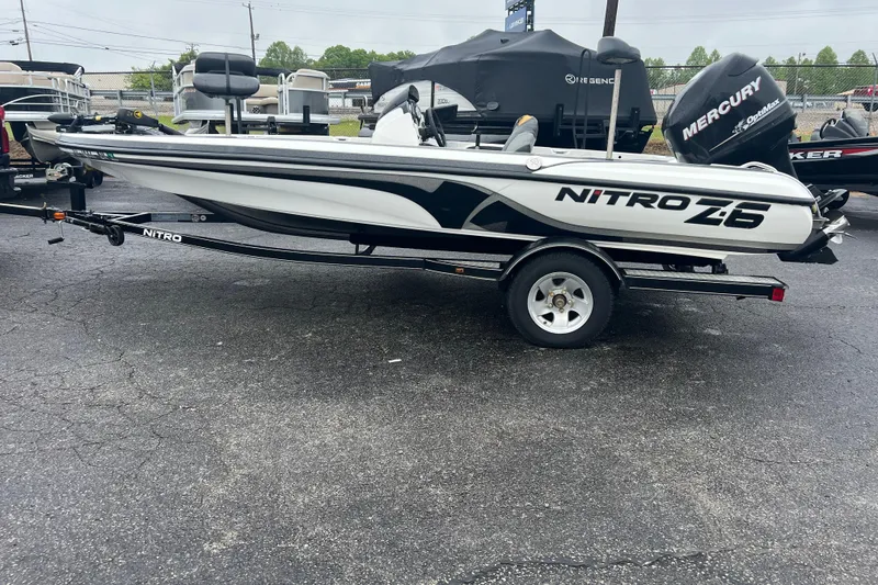 The Image of 2011 Nitro Z-6 boat on trailer, featuring sleek design and Mercury engine. - 0