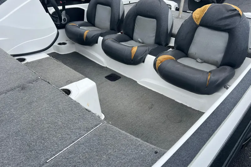 Slide: The Image of Interior of a 2011 Nitro Z-6 boat with worn seating and carpeted flooring. - 4