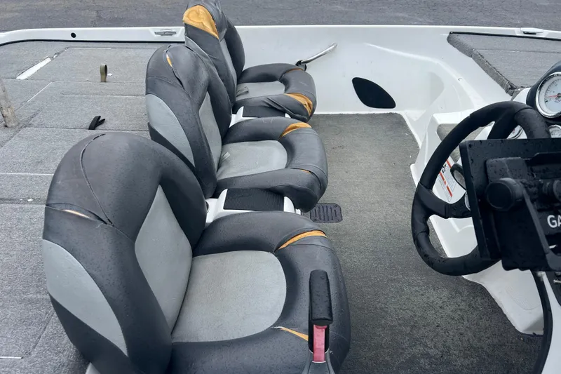 Slide: The Image of Interior of a 2011 Nitro Z-6 boat with worn gray and black seats. - 5