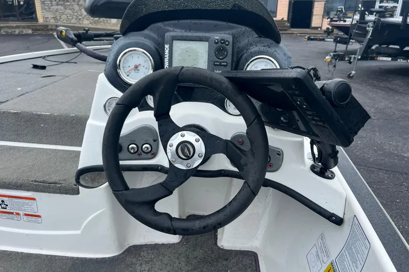 Slide: The Image of Steering console of a 2011 Nitro Z-6 boat with gauges and controls. - 6