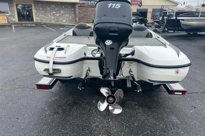 Slide: The Image of 2011 Nitro Z-6 boat with outboard motor, parked on a trailer in a dealership lot. - 8
