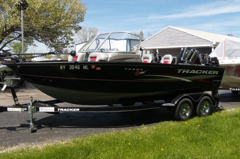 Slide: The Image of 2016 Tracker Targa V-18 WT boat on trailer, parked outdoors near a building. - 11