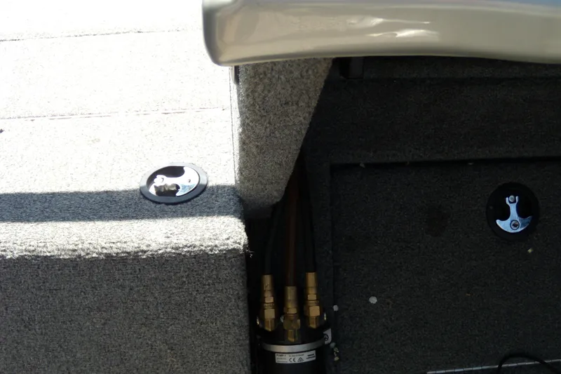Slide: The Image of Interior view of a 2016 Tracker Targa V-18 WT boat, showing carpeted flooring and fittings. - 14