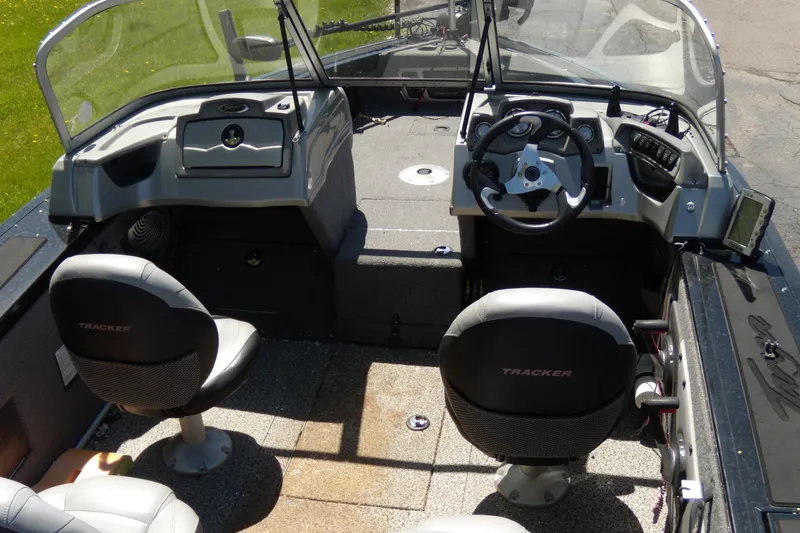 Slide: The Image of 2016 Tracker Targa V-18 WT boat interior with steering wheel and seating. - 2