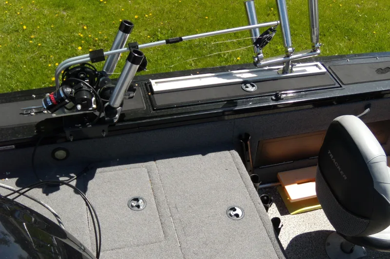 Slide: The Image of 2016 Tracker Targa V-18 WT boat interior with fishing rod holders and seating. - 3