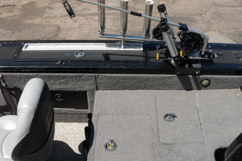 Slide: The Image of 2016 Tracker Targa V-18 WT boat interior with fishing rod holders and seating. - 4
