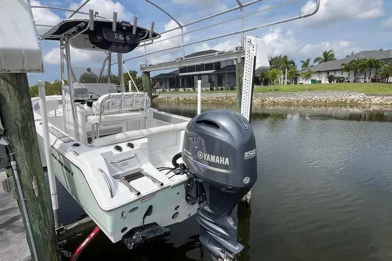 Slide: The Image of 2015 Sea Hunt Ultra 211 boat with Yamaha 150 engine docked by waterfront homes. - 10
