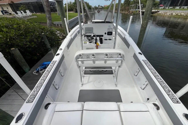 Slide: The Image of 2015 Sea Hunt Ultra 211 boat interior with helm, seating, and waterway view. - 11