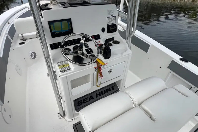 Slide: The Image of 2015 Sea Hunt Ultra 211 boat cockpit with steering wheel and navigation display. - 12