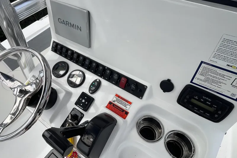 Slide: The Image of Control panel of a 2015 Sea Hunt Ultra 211 boat with Garmin navigation system. - 14