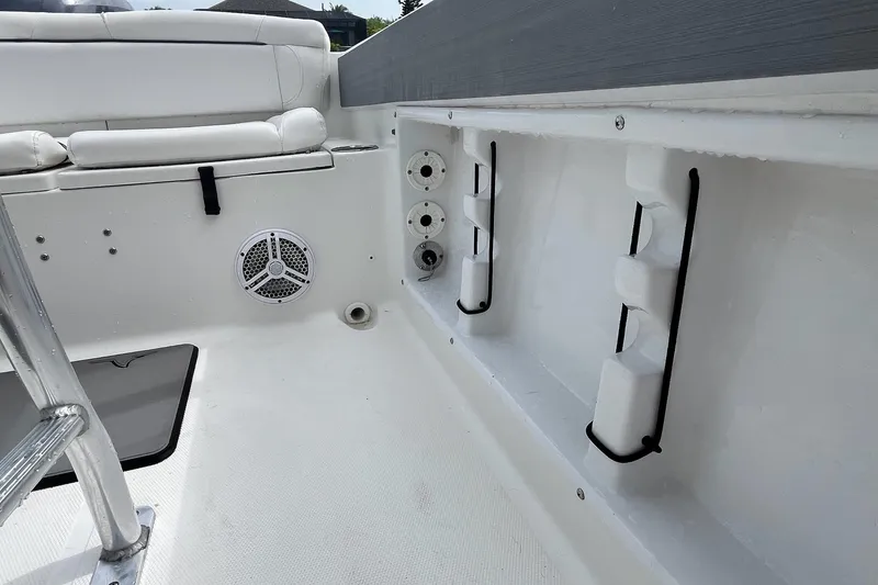Slide: The Image of Interior view of a 2015 Sea Hunt Ultra 211 boat, featuring seating and storage compartments. - 4