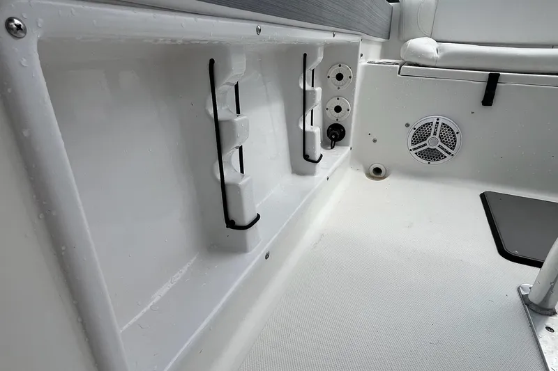 Slide: The Image of Interior of 2015 Sea Hunt Ultra 211 boat, featuring storage and speaker details. - 5
