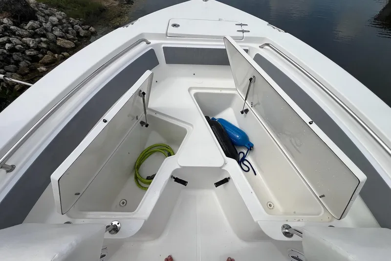 Slide: The Image of Bow storage compartments on a 2015 Sea Hunt Ultra 211 boat, featuring open hatches and stored gear. - 8