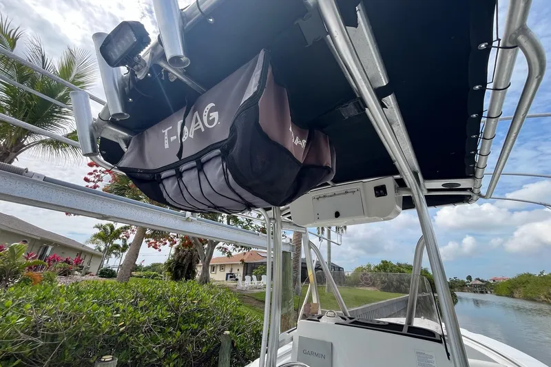 Slide: The Image of 2015 Sea Hunt Ultra 211 boat with T-Bag storage under T-top, canal view. - 9