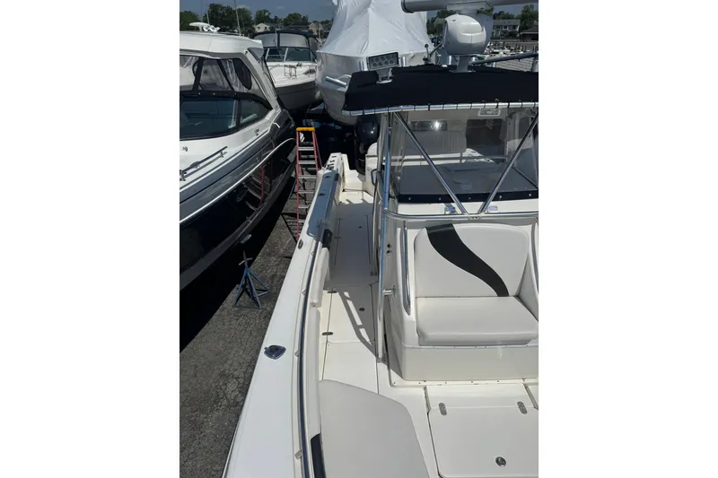 Slide: The Image of 2007 Fountain 34 Center Console boat docked alongside other vessels. - 11