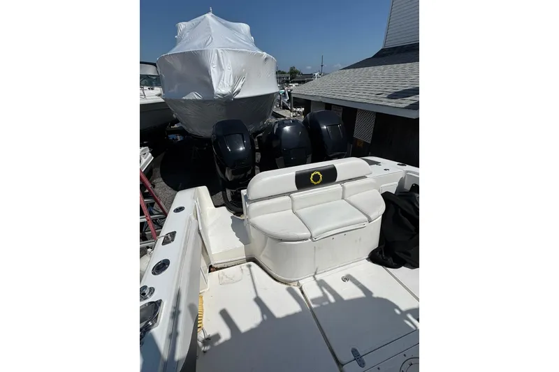 Slide: The Image of 2007 Fountain 34 Center Console boat with triple outboard engines, docked outdoors. - 17