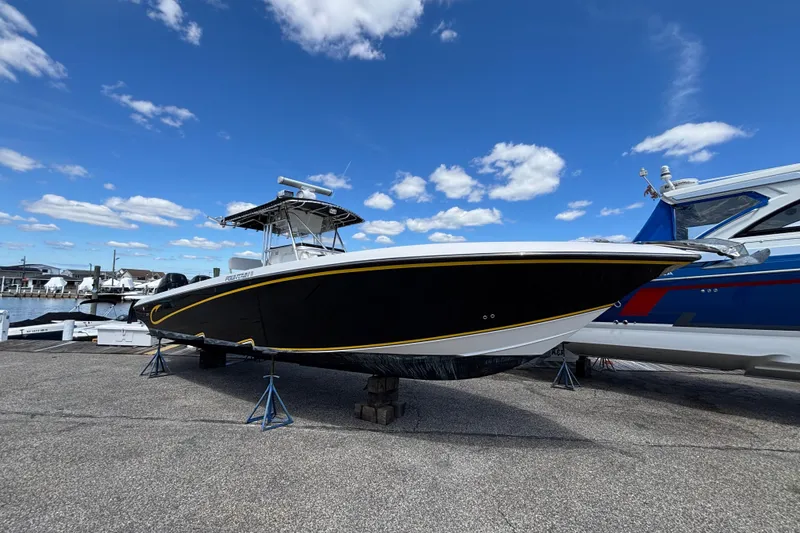 Slide: The Image of 2007 Fountain 34 Center Console boat on stands under a blue sky. - 3