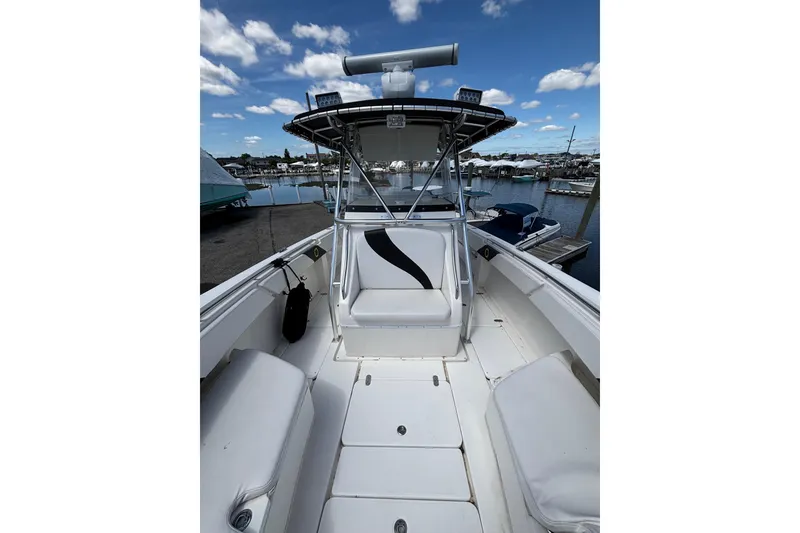 Slide: The Image of 2007 Fountain 34 Center Console boat docked at marina under blue sky. - 5