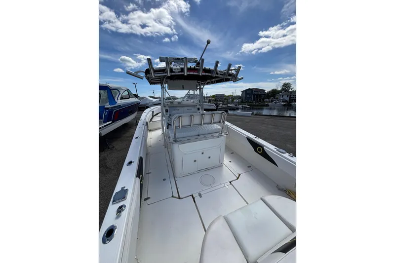 Slide: The Image of 2007 Fountain 34 Center Console boat docked under a clear blue sky. - 7