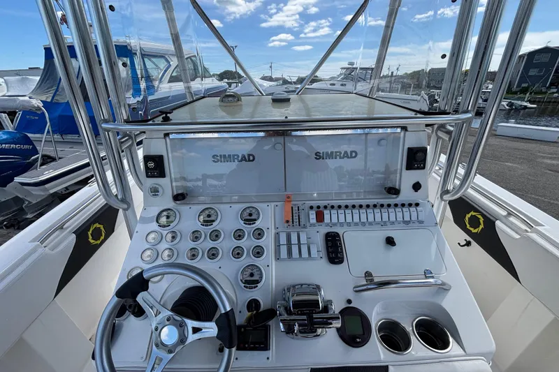 Slide: The Image of Center console of 2007 Fountain 34, featuring Simrad electronics and steering wheel. - 8
