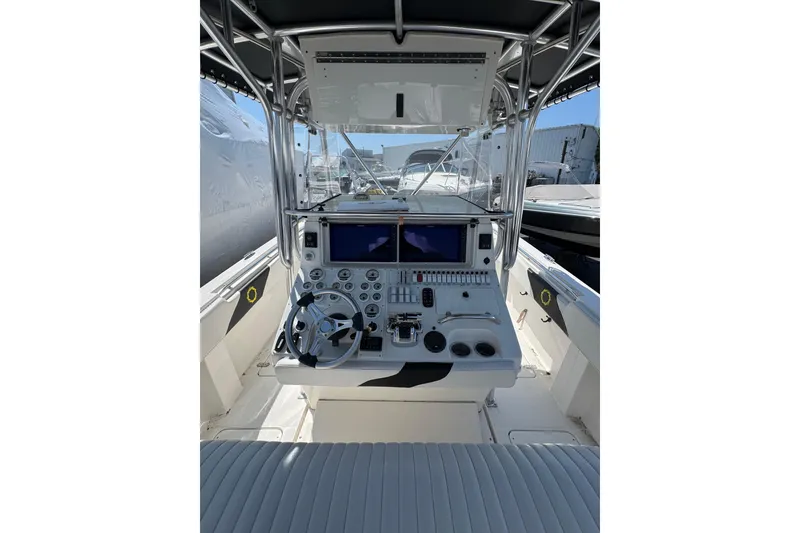 Slide: The Image of 2007 Fountain 34 Center Console boat cockpit with steering wheel and control panel. - 9