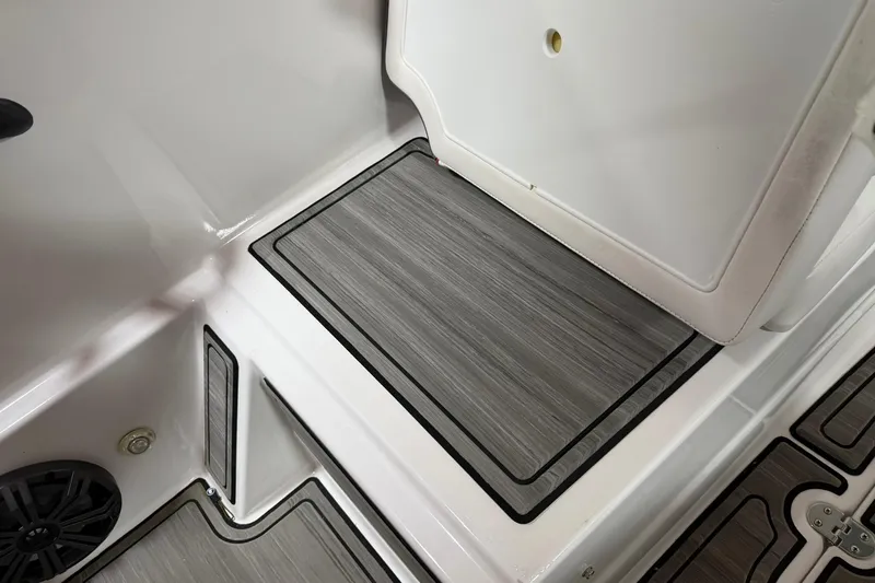 Slide: The Image of 2024 Tahoe T18 boat interior with gray non-slip flooring and storage compartment. - 10