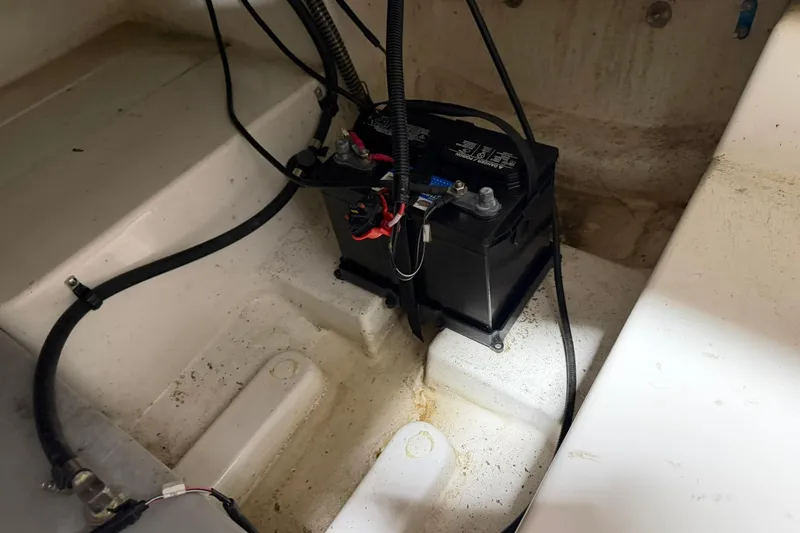 Slide: The Image of Battery compartment of a 2024 Tahoe T18 boat, showing wiring and connections. - 15
