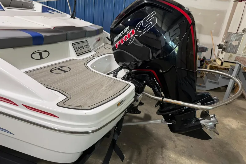 Slide: The Image of 2024 Tahoe T18 boat with Mercury Pro XS engine, featuring sleek design and "Lake Life" decal. - 2