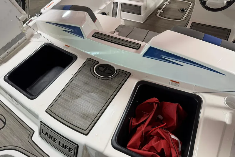 Slide: The Image of 2024 Tahoe T18 boat interior with storage compartments and "Lake Life" sign. - 4