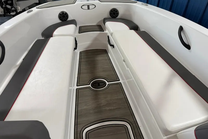 Slide: The Image of 2024 Tahoe T18 boat interior with white seating, wood-style flooring, and modern design elements. - 5