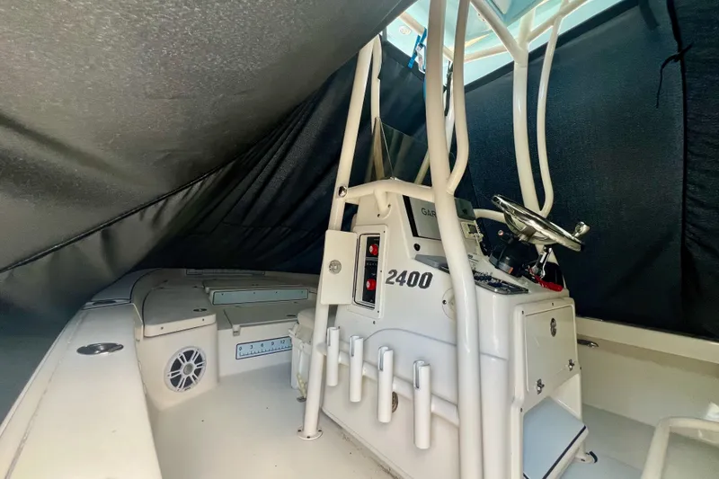 Slide: The Image of 2017 Pathfinder 2400 TRS boat interior with console and steering wheel under cover. - 3