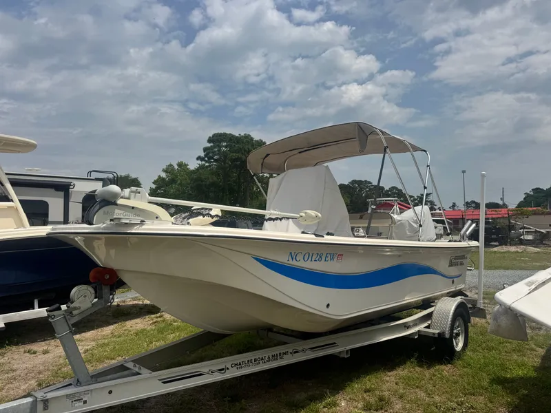 The Image of 2022 Carolina Skiff 19 LS boat on trailer under cloudy sky. - 0