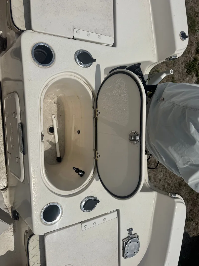 Slide: The Image of 2022 Carolina Skiff 19 LS boat with open storage compartment lid. - 10