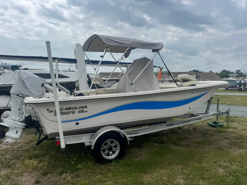 Slide: The Image of 2022 Carolina Skiff 19 LS boat on trailer outdoors. - 3