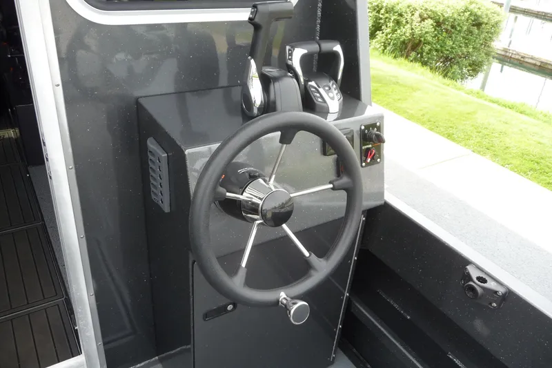 Slide: The Image of Steering console of 2025 North River 2700s boat, featuring modern controls and sleek design. - 16