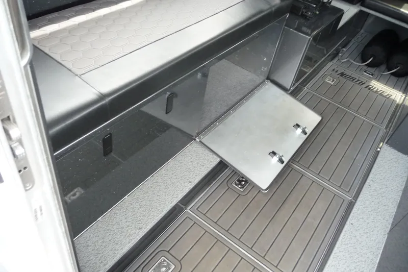 Slide: The Image of Interior of 2025 North River 2700s boat with storage compartment open. - 19