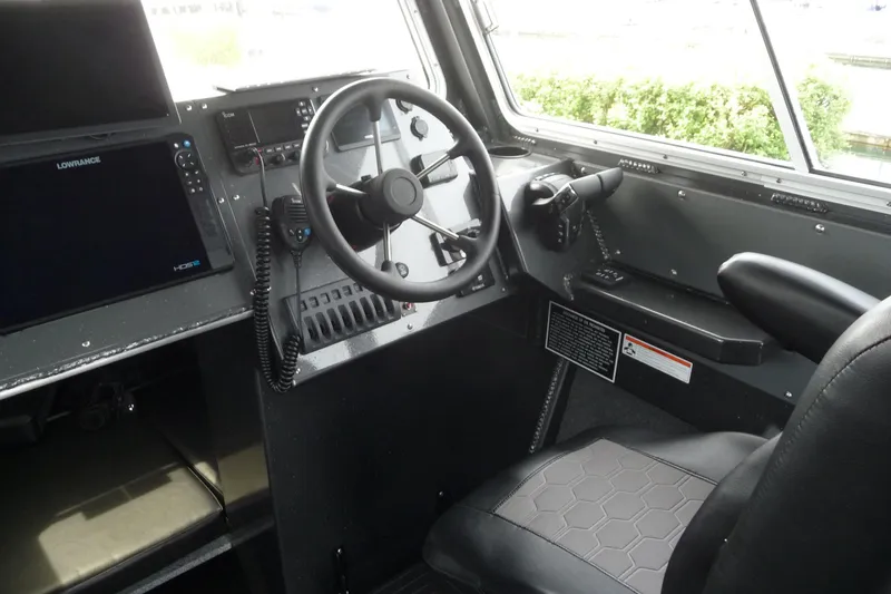 Slide: The Image of Interior cockpit of 2025 North River 2700s boat with steering wheel and navigation equipment. - 20