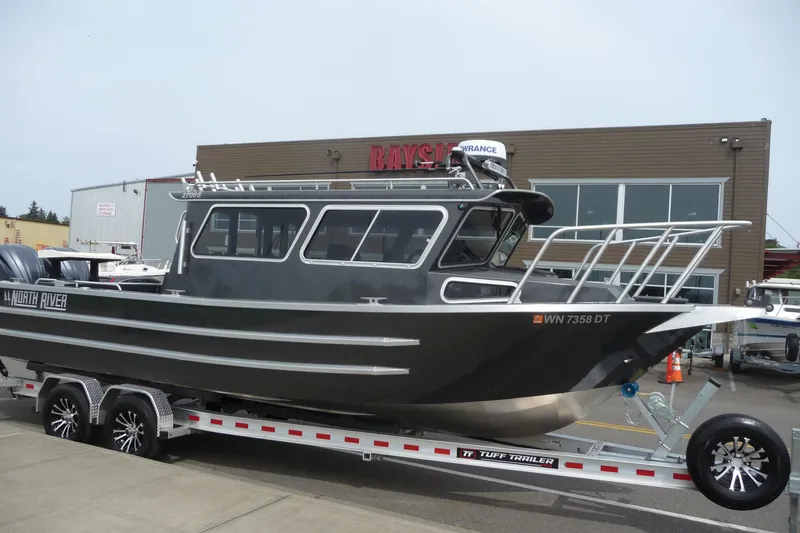Slide: The Image of 2025 North River 2700s boat on trailer, parked outside dealership. - 4