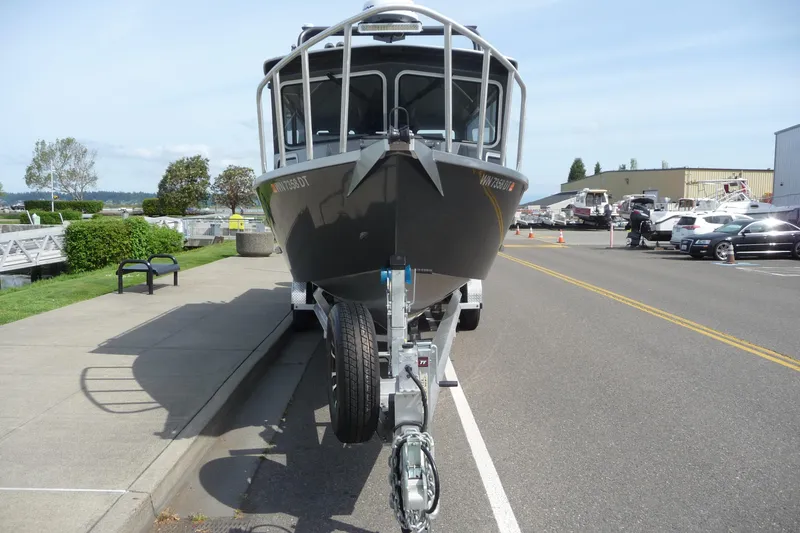 Slide: The Image of 2025 North River 2700s boat on trailer, parked on a street near a marina. - 5
