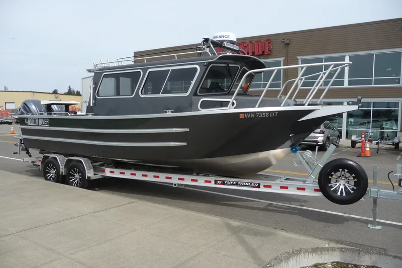 Slide: The Image of 2025 North River 2700s boat on trailer, parked outside a building. - 7