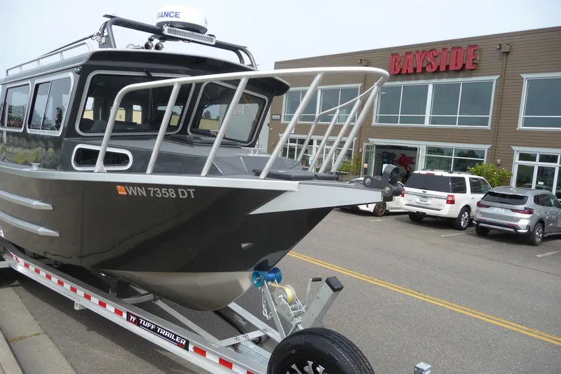 Slide: The Image of 2025 North River 2700s boat on trailer outside Bayside building. - 9
