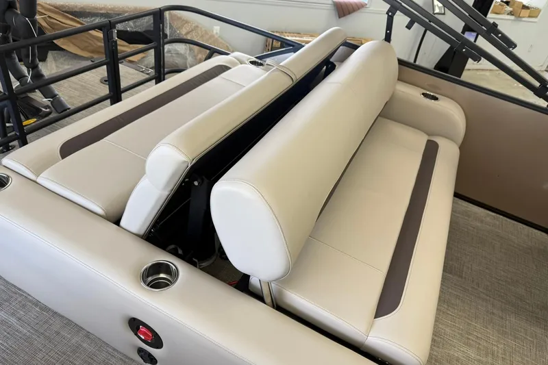 Slide: The Image of 2026 Bentley Pontoons Legacy 223 Swingback interior with beige seating and cup holders. - 12