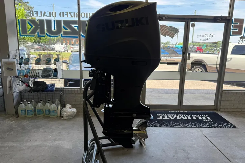 Slide: The Image of Suzuki outboard motor displayed indoors, with Bentley Pontoons Legacy 223 Swingback, 2026 model. - 14