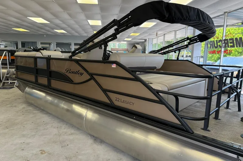 Slide: The Image of 2026 Bentley Pontoons Legacy 223 Swingback in showroom, featuring sleek design and comfortable seating. - 3