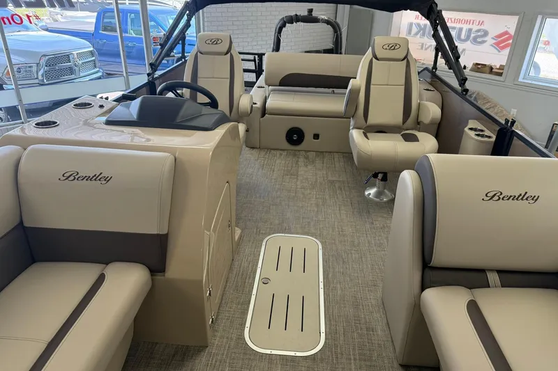 Slide: The Image of 2026 Bentley Pontoons Legacy 223 Swingback interior with beige seating and steering console. - 4