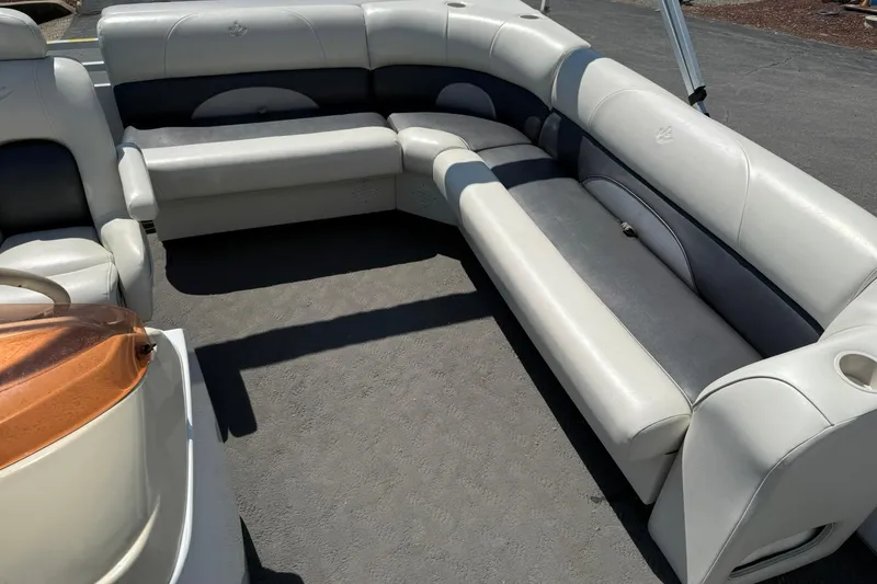 Slide: The Image of 2010 JC 21 Neptoon boat interior with spacious, cushioned seating and sleek design. - 10