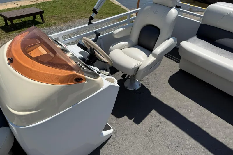 Slide: The Image of 2010 JC 21 Neptoon boat interior with steering console and comfortable seating. - 11