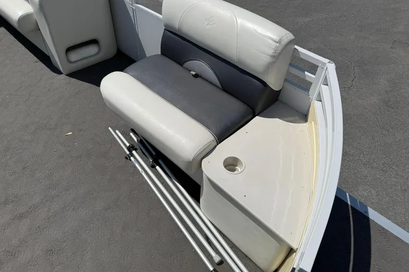 Slide: The Image of 2010 JC 21 Neptoon boat seating area with cup holder and metal rods. - 8